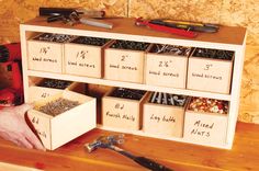 a man is holding a toolbox with drawers full of screwdrives and other tools