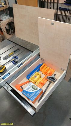 the drawer is open to show tools inside