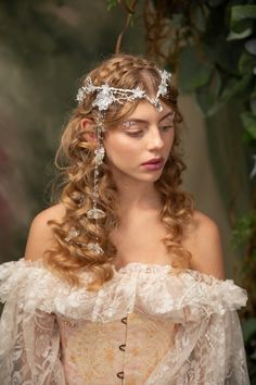 Romantic wedding tiara in winter frozen design :) Perfect for renaissance festivals, parties, weddings, photoshoots, Halloween, carnivals, ... The tiara is made of artificial flowers, beads and other arranging material. It's also possible to purchase a veil that can be attached to the tiara Model: Ester Photo: Michaela durisova photography When stored in dry and dark place, our products last 10-15 years. We can also make you other matching accessories. Please message me for more information. :) ---------------------------------------------------------------- SHIPPING INFO FOR EU ORDERS: Standard shipping: Your package will arrive in about 5-8 days after it has been shipped.  Express shipping: Your package will arrive in about 1-3 days after it has been shipped.  FOR INTERNATIONAL ORDERS: W Veil Transparent, Tiara With Veil, Fae Wedding, Bridal Diadem, Wedding Crown Veil, Frozen Design, Flower Crown Veil, Elven Tiara, Festival Crown