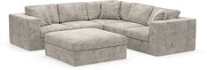 a sectional couch and ottoman with matching footstools in light grey velvet upholster