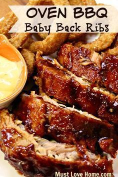 bbq baby back ribs on a plate with dipping sauce