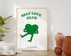 a green poster with the words self love club on it next to potted plants