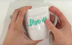 a person holding a coffee mug with writing on it