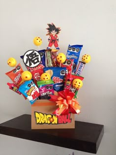 a box filled with lots of candy and candies on top of a wooden shelf