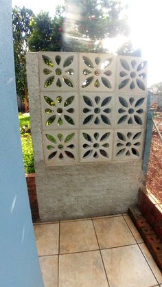 an outdoor shower area with tiled floor and walls