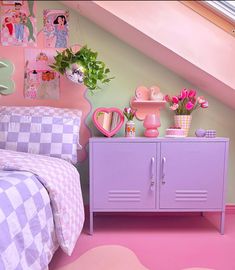 a bedroom with pink and green decor on the wall next to a purple dresser in front of a bed