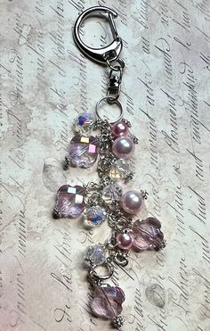 a close up of a keychain with beads and charms on it's side