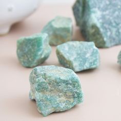 some green rocks sitting on top of a table