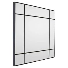 a black and white wall mirror with squares on the bottom, in front of a white background