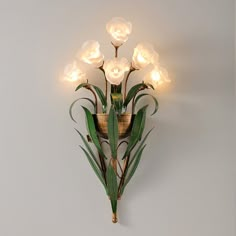 a wall mounted light with flowers on it