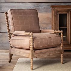 a wooden chair sitting on top of a rug