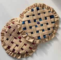 two pie crusts with blue and red designs on them sitting next to each other