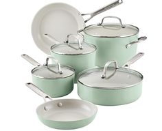 green pots and pans are stacked on top of each other