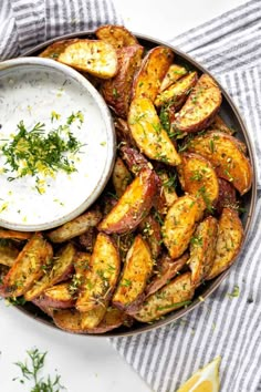 baked potato wedges with ranch dip in a bowl