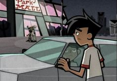 a cartoon character holding up a book in front of a car