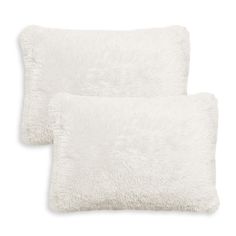 two white fluffy pillows sitting next to each other