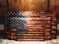 an american flag made out of wood sitting on top of a counter next to a wall