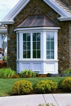 a brick house with white trim and windows