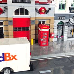 a toy truck is parked in front of a building