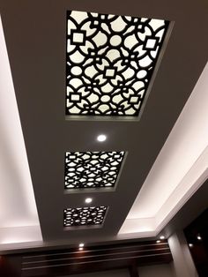 the ceiling in this room is decorated with intricate patterns and lights, along with recessed lighting