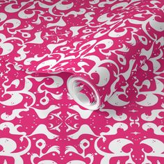 a pink wallpaper with white skulls and hearts on it's face, as well as a roll of paper