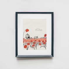 an art piece hanging on the wall with red flowers in front of it and a black frame