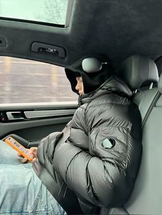 a man sitting in the back seat of a car