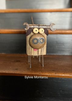 an animal made out of wood sitting on top of a wooden table