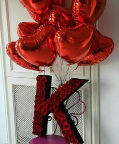 some red balloons that are in the shape of k