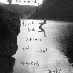 a woman jumping off the edge of a cliff into water with words written on it