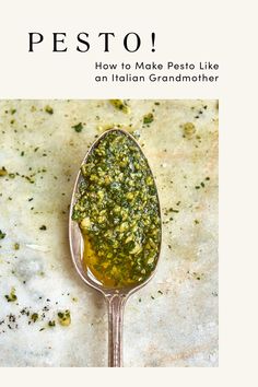 a spoon full of pesto sitting on top of a table