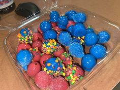 blue and red desserts in a plastic container on a counter