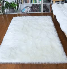 a white rug is on the floor in front of a bookshelf