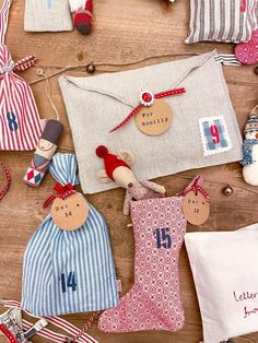 several christmas ornaments are laid out on a wooden surface, including stockings and stocking