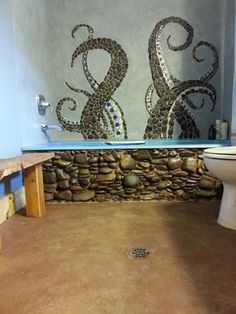 a bathroom with an octopus mural on the wall