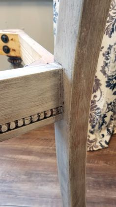 the back end of a wooden chair with holes in it