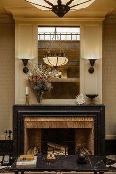 a living room filled with furniture and a fire place in front of a mirror on the wall