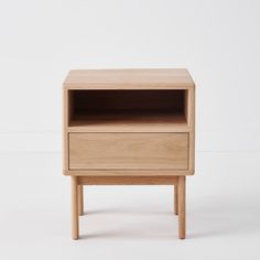 a small wooden table with two drawers on one side and an open drawer on the other