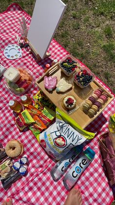 a picnic table with food and drinks on it