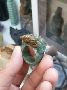 Vintage, collector's piece, auspicious Chinese Dragon carved Jade ring. Glossy, semitranslucent, grayish green with patches of red, Type A natural Jadeite (non-bleached, non-dyed, non-treated material). Ring size US 9.5 (61), weighs 17.64 grams, width 1.2 cm, height of Dragon from shank 1 cm. Unique Carved Round Rings, Carved Jade Rings As A Gift, Carved Jade Rings For A Gift, Carved Green Jade Rings, Green Carved Jade Rings, Green Carved Rings Perfect For Gifts, Collectible Jade Gemstone Rings, Green Carved Rings For Anniversary, Green Spiritual Ring For Collectors