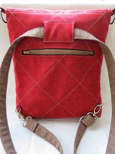 a red purse sitting on top of a white table