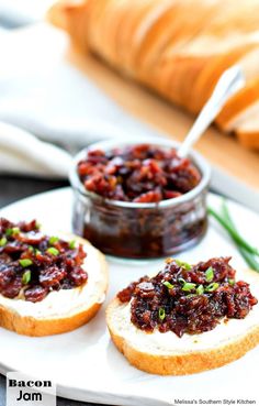 two pieces of bread on a plate with cranberry sauce and green onions in the background