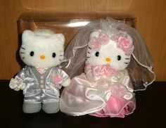 two hello kitty dolls dressed up as bride and groom