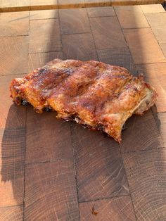 a piece of meat sitting on top of a wooden table