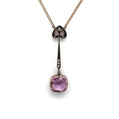 This elegant drop necklace features a captivating 5.0 carat cushion-cut pink topaz as its centerpiece. The pendant is meticulously crafted with a combination of 14k gold and silver, highlighted by a delicate yellow gold setting. Accentuating the topaz, old mine-cut white diamonds add a subtle sparkle. The design is refined and graceful, offering a touch of sophistication to any ensemble. This piece reflects exquisite craftsmanship and timeless beauty.  Length including chain: 20 inches  Weight: 7.0 grams Gold Silver Necklace, Pink Topaz, Yellow Gold Setting, Antique Pink, Jewelry Show, Fine Jewellery Necklace, Drop Necklace, White Diamonds, Cushion Cut