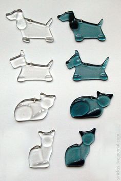 six glass dog magnets in various shapes and sizes