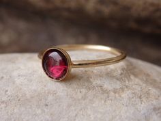 Garnet Gold Ring, Red Gemstone Stacking Ring, Dark Red Minimalist Ring, January Birthstone, Gold Filled Ring, Garnet jewelry, Red Stone Ring This red garnet gold stacking ring will be a perfect gift for women. It is made of 14k gold filled and garnet stone. Measurements: Size- all The center stone is 6 mm The ring will be packed in a gift box. FOR MY RINGS COLLECTION HERE: https://www.etsy.com/il-en/shop/rebekajewelry?section_id=14282915&ref=shopsection_leftnav_9 TO GET TO MY SHOP: https://w Red Dainty Stackable Jewelry, Dainty Red Stackable Jewelry, Dainty Red Ruby Ring As A Gift, Dainty Red Round Jewelry, Minimalist Red Jewelry For Wedding, Red Minimalist Jewelry For Wedding, Red Birthstone Stackable Rings Fine Jewelry, Red Ruby Ring With Bezel Setting Gift, Fine Jewelry Red Birthstone Stackable Rings