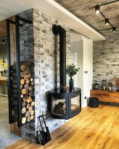 a living room filled with furniture and a fire place next to a wall mounted fireplace