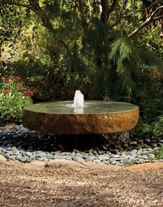 a bird is sitting on top of a fountain