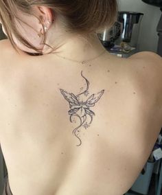 a woman with a tattoo on her back